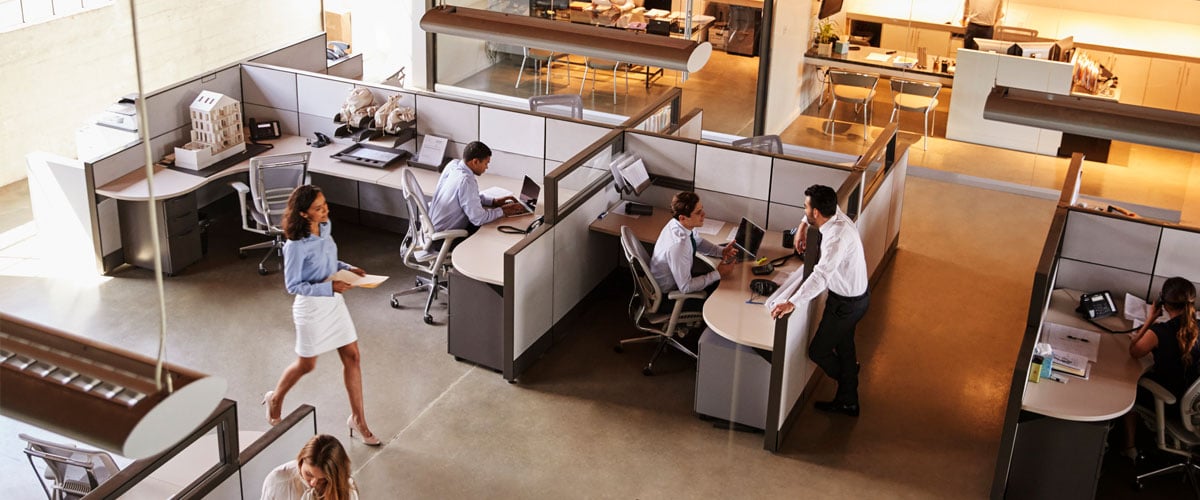 Modern office with woman walking down the main aisle