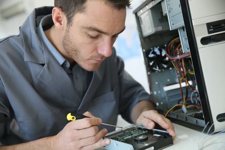 Technician fixing computer hardware.jpeg