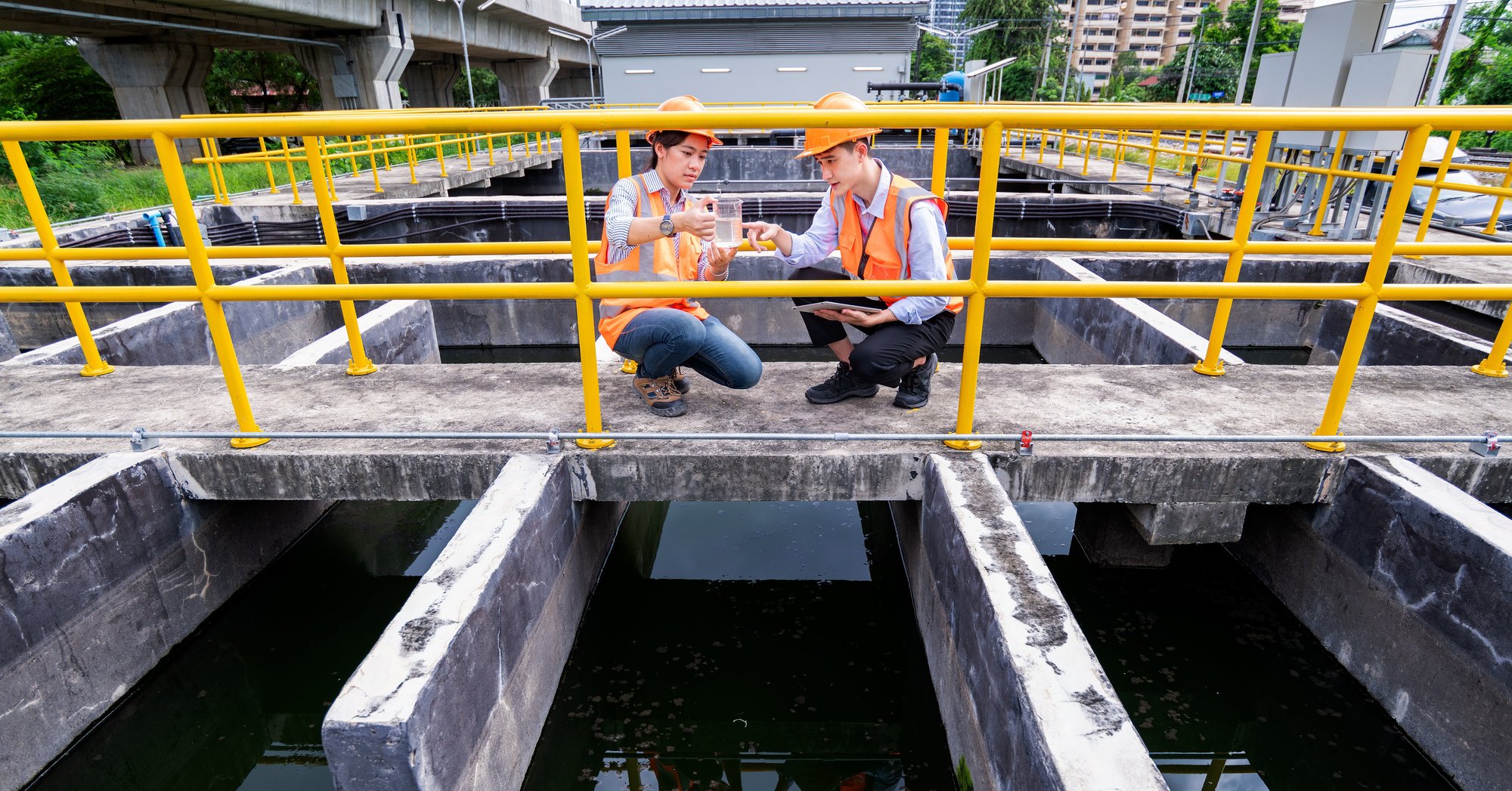 engineer-take-water-from-wastewater-treatment-pond-2023-11-27-05-18-03-utc