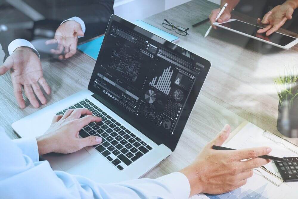 business documents on office table with smart phone and digital tablet and graph business diagram and man working in the background business documents on office table with smart phone and digital tablet and graph business diagram and man working in the background
